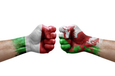 Two hands punch to each others on white background. Country flags painted fists, conflict crisis concept between italy and wales