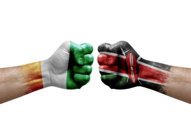 Two hands punch to each others on white background. Country flags painted fists, conflict crisis concept between ivory coast and kenya