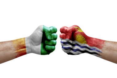 Two hands punch to each others on white background. Country flags painted fists, conflict crisis concept between ivory coast and kiribati