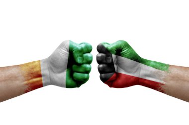 Two hands punch to each others on white background. Country flags painted fists, conflict crisis concept between ivory coast and kuwait