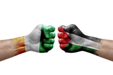 Two hands punch to each others on white background. Country flags painted fists, conflict crisis concept between ivory coast and palestine