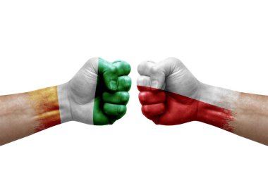 Two hands punch to each others on white background. Country flags painted fists, conflict crisis concept between ivory coast and poland