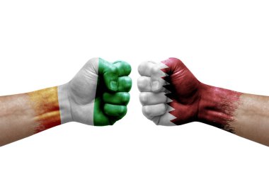 Two hands punch to each others on white background. Country flags painted fists, conflict crisis concept between ivory coast and qatar