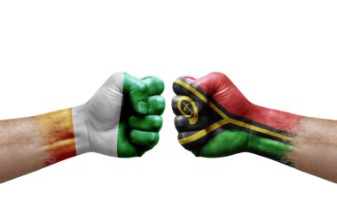 Two hands punch to each others on white background. Country flags painted fists, conflict crisis concept between ivory coast and vanuatu