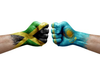 Two hands punch to each others on white background. Country flags painted fists, conflict crisis concept between jamaica and kazakhstan