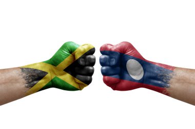 Two hands punch to each others on white background. Country flags painted fists, conflict crisis concept between jamaica and laos