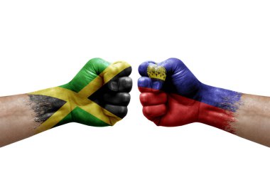 Two hands punch to each others on white background. Country flags painted fists, conflict crisis concept between jamaica and liechtenstein