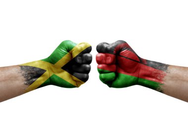 Two hands punch to each others on white background. Country flags painted fists, conflict crisis concept between jamaica and malawi