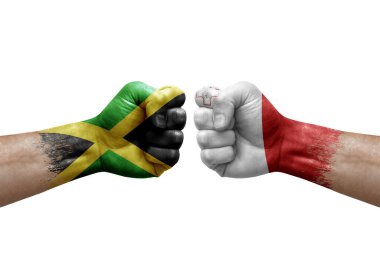 Two hands punch to each others on white background. Country flags painted fists, conflict crisis concept between jamaica and malta