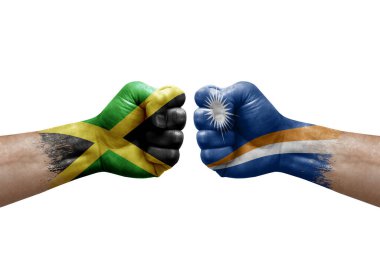 Two hands punch to each others on white background. Country flags painted fists, conflict crisis concept between jamaica and marshall islands