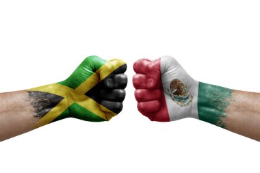 Two hands punch to each others on white background. Country flags painted fists, conflict crisis concept between jamaica and mexico