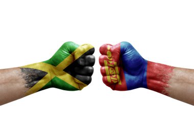 Two hands punch to each others on white background. Country flags painted fists, conflict crisis concept between jamaica and mongolia