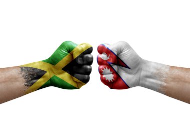 Two hands punch to each others on white background. Country flags painted fists, conflict crisis concept between jamaica and nepal