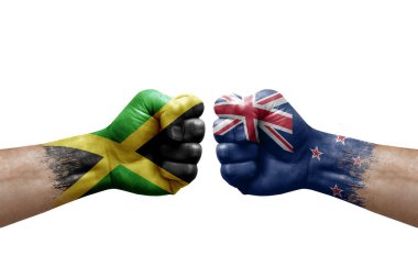 Two hands punch to each others on white background. Country flags painted fists, conflict crisis concept between jamaica and new zealand