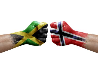 Two hands punch to each others on white background. Country flags painted fists, conflict crisis concept between jamaica and norway