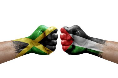 Two hands punch to each others on white background. Country flags painted fists, conflict crisis concept between jamaica and palestine