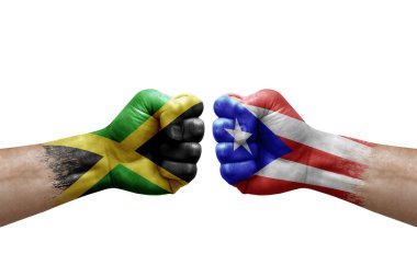 Two hands punch to each others on white background. Country flags painted fists, conflict crisis concept between jamaica and puerto rico