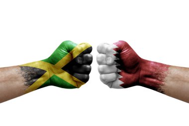 Two hands punch to each others on white background. Country flags painted fists, conflict crisis concept between jamaica and qatar