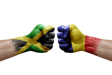 Two hands punch to each others on white background. Country flags painted fists, conflict crisis concept between jamaica and romania