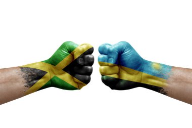 Two hands punch to each others on white background. Country flags painted fists, conflict crisis concept between jamaica and rwanda