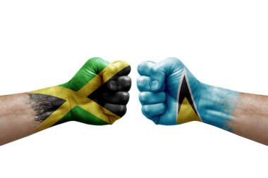 Two hands punch to each others on white background. Country flags painted fists, conflict crisis concept between jamaica and saint lucia