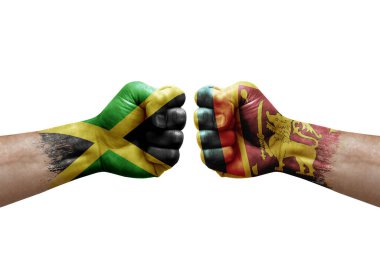 Two hands punch to each others on white background. Country flags painted fists, conflict crisis concept between jamaica and sri lanka
