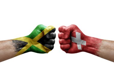 Two hands punch to each others on white background. Country flags painted fists, conflict crisis concept between jamaica and switzerland