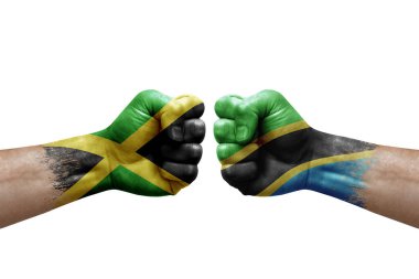 Two hands punch to each others on white background. Country flags painted fists, conflict crisis concept between jamaica and tanzania
