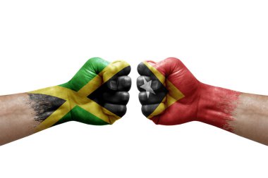 Two hands punch to each others on white background. Country flags painted fists, conflict crisis concept between jamaica and timor leste