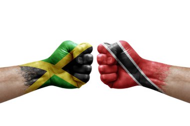 Two hands punch to each others on white background. Country flags painted fists, conflict crisis concept between jamaica and tobago