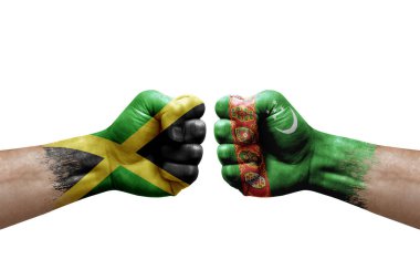 Two hands punch to each others on white background. Country flags painted fists, conflict crisis concept between jamaica and turkmenistan