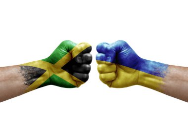Two hands punch to each others on white background. Country flags painted fists, conflict crisis concept between jamaica and ukraine