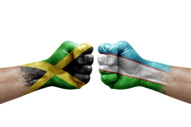 Two hands punch to each others on white background. Country flags painted fists, conflict crisis concept between jamaica and uzbekistan