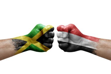 Two hands punch to each others on white background. Country flags painted fists, conflict crisis concept between jamaica and yemen