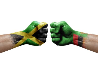 Two hands punch to each others on white background. Country flags painted fists, conflict crisis concept between jamaica and zambia