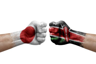 Two hands punch to each others on white background. Country flags painted fists, conflict crisis concept between japan and kenya