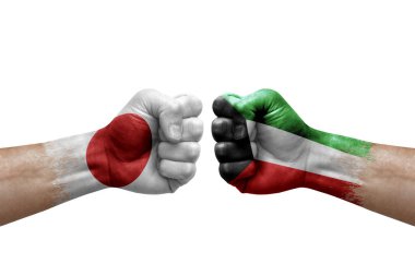 Two hands punch to each others on white background. Country flags painted fists, conflict crisis concept between japan and kuwait