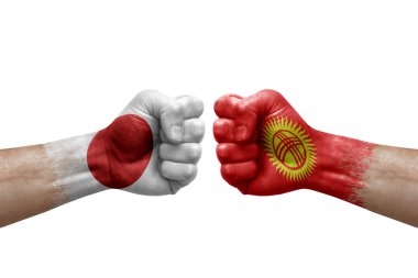 Two hands punch to each others on white background. Country flags painted fists, conflict crisis concept between japan and kyrgyzstan