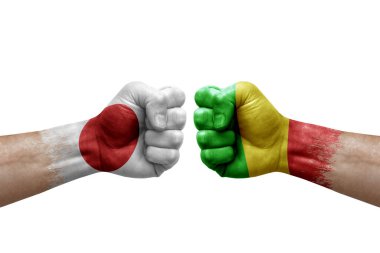 Two hands punch to each others on white background. Country flags painted fists, conflict crisis concept between japan and mali