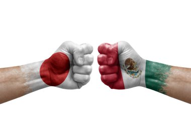 Two hands punch to each others on white background. Country flags painted fists, conflict crisis concept between japan and mexico