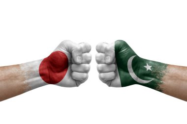 Two hands punch to each others on white background. Country flags painted fists, conflict crisis concept between japan and pakistan