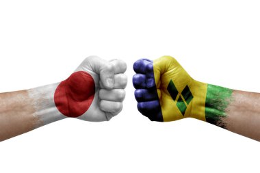 Two hands punch to each others on white background. Country flags painted fists, conflict crisis concept between japan and saint vincent and the grenadines