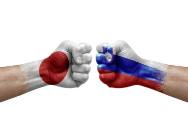 Two hands punch to each others on white background. Country flags painted fists, conflict crisis concept between japan and slovenia
