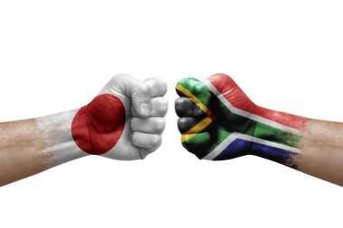 Two hands punch to each others on white background. Country flags painted fists, conflict crisis concept between japan and south africa
