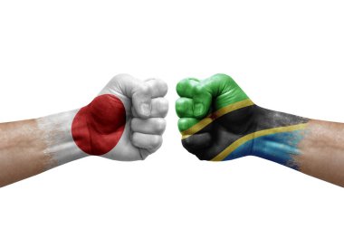 Two hands punch to each others on white background. Country flags painted fists, conflict crisis concept between japan and tanzania