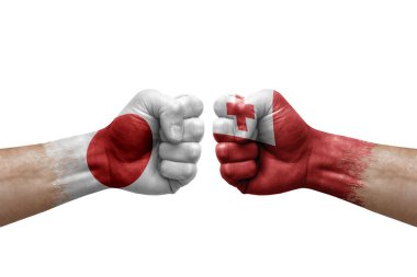 Two hands punch to each others on white background. Country flags painted fists, conflict crisis concept between japan and tonga