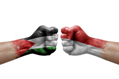 Two hands punch to each others on white background. Country flags painted fists, conflict crisis concept between jordan and monaco