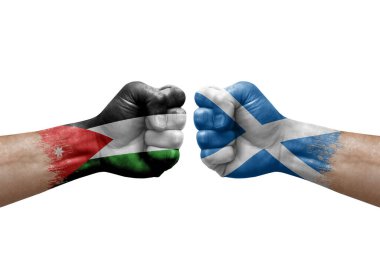 Two hands punch to each others on white background. Country flags painted fists, conflict crisis concept between jordan and scotland