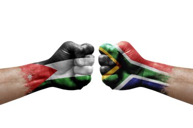 Two hands punch to each others on white background. Country flags painted fists, conflict crisis concept between jordan and south africa