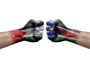 Two hands punch to each others on white background. Country flags painted fists, conflict crisis concept between jordan and south sudan